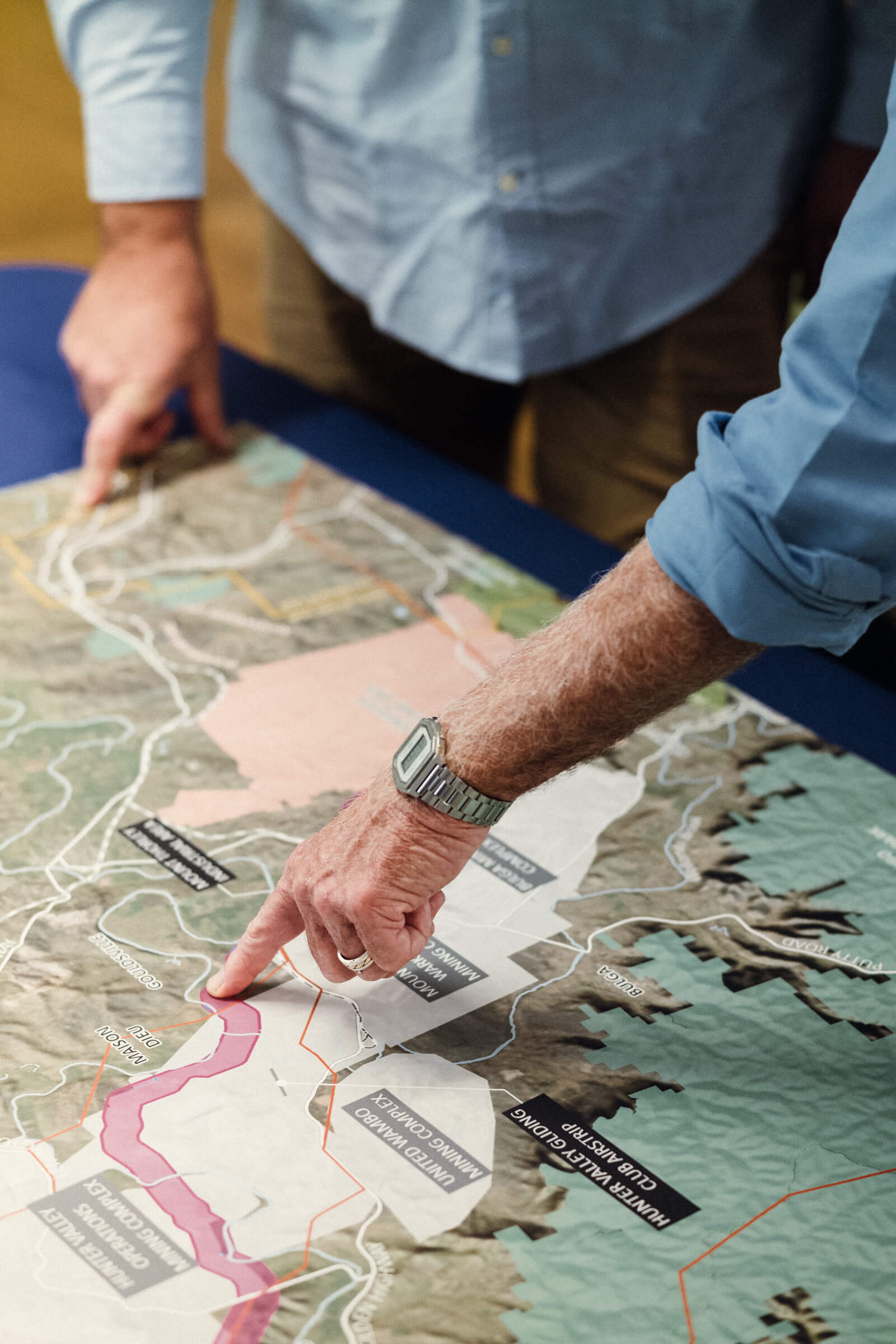 Pointing to a place on a map Photo Credit: Ian Tyley Photography
